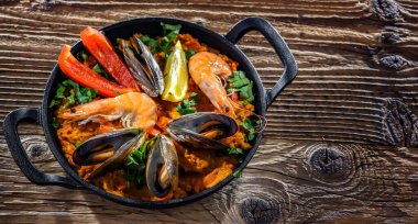 Seafood paella served in a cast iron pan.