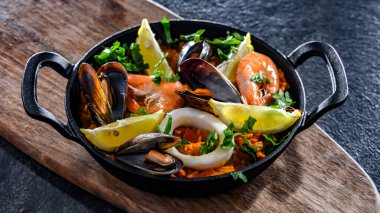 Seafood paella served in a cast iron pan.