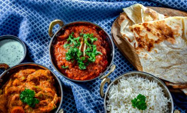 Hot madras paneer and vegetable masala with basmati rice served in original indian karahi pots.
