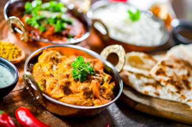 Hot madras paneer and vegetable masala with basmati rice served in original indian karahi pots.