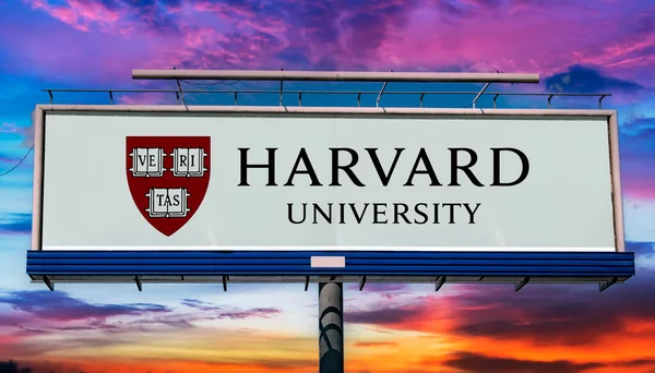 stock image POZNAN, POL - MAR 7, 2023: Advertisement billboard displaying logo of Harvard University, a private Ivy League research university in Cambridge, Massachusetts