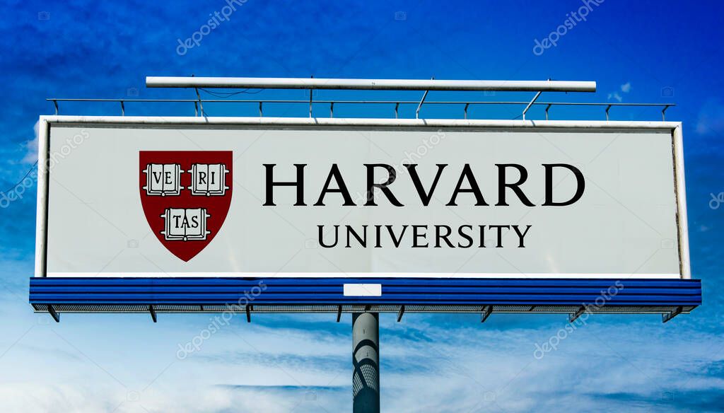 POZNAN, POL - MAR 7, 2023: Advertisement billboard displaying logo of Harvard University, a private Ivy League research university in Cambridge, Massachusetts