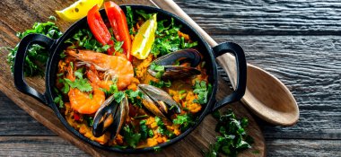 Seafood paella served in a cast iron pan.