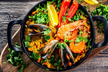 Seafood paella served in a cast iron pan.