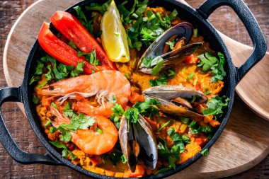 Seafood paella served in a cast iron pan.