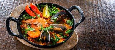 Seafood paella served in a cast iron pan.