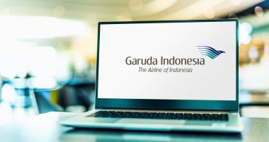 POZNAN, POL - MAR 15, 2021: Laptop computer displaying logo of PT Garuda Indonesia, the flag carrier of Indonesia clipart