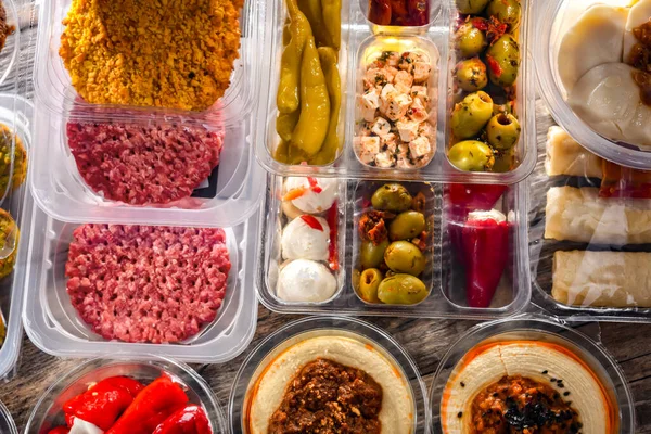 stock image A display of a variety of prepackaged food products in plastic boxes.