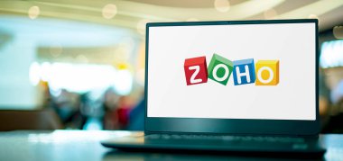 POZNAN, POL - APR 7, 2022: Laptop computer displaying logo of Zoho Corporation, an Indian software development company with headquarters in Chennai, India clipart