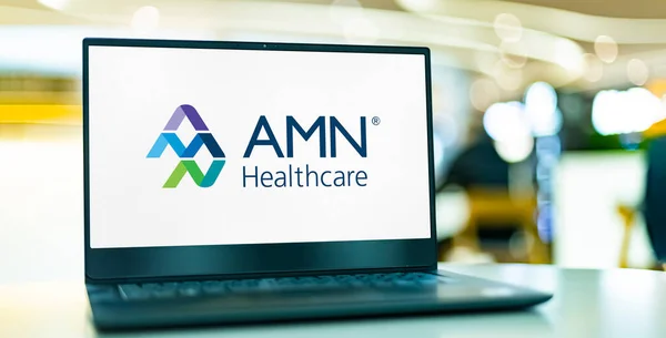 stock image POZNAN, POL - MAR 8, 2023: Laptop computer displaying logo of AMN Healthcare Services, Inc.