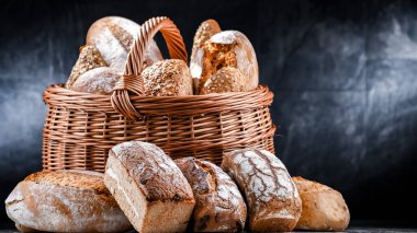Wicker basket with bakery products including loaves of bread and rolls