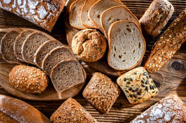 Assorted bakery products including loaves of bread and rolls