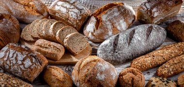 Assorted bakery products including loaves of bread and rolls