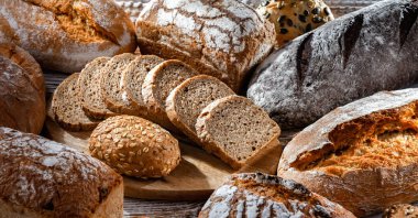 Assorted bakery products including loaves of bread and rolls