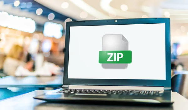 stock image Laptop computer displaying the icon of ZIP file