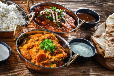 Hot madras paneer and vegetable masala with basmati rice served in original indian karahi pots.