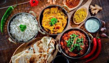 Hot madras paneer and vegetable masala with basmati rice served in original indian karahi pots.