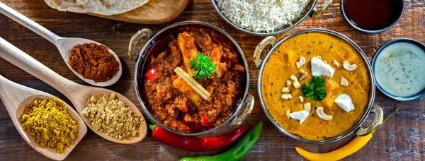 Stock image Composition with indian dishes: madras paneer, palak paneer and shahi paneer with basmati rice served in original indian karahi pots