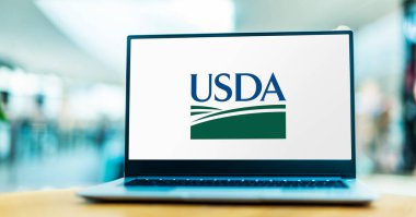 POZNAN, POL - MAY 1, 2021: Laptop computer displaying logo of USDA, the federal executive department responsible for developing and executing federal laws related to farming, forestry and food clipart