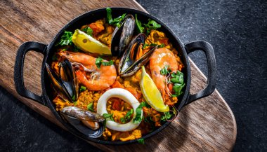 Seafood paella served in a cast iron pan.