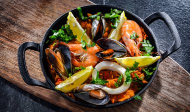 Seafood paella served in a cast iron pan.