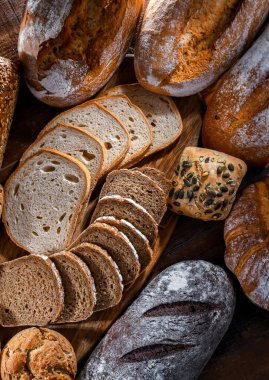 Assorted bakery products including loaves of bread and rolls