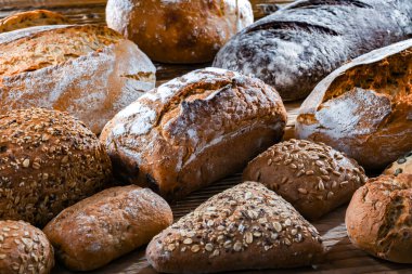 Assorted bakery products including loaves of bread and rolls