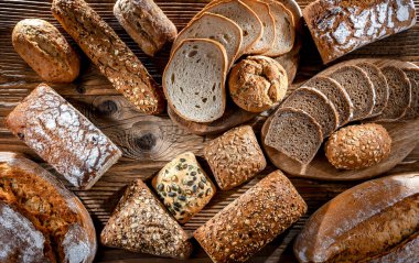 Assorted bakery products including loaves of bread and rolls