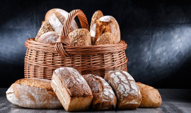 Wicker basket with bakery products including loaves of bread and rolls