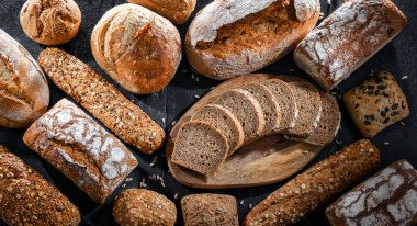 Assorted bakery products including loaves of bread and rolls