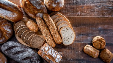 Assorted bakery products including loaves of bread and rolls