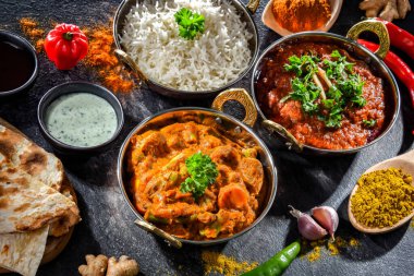 Hot madras paneer and vegetable masala with basmati rice served in original indian karahi pots.