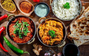 Hot madras paneer and vegetable masala with basmati rice served in original indian karahi pots.