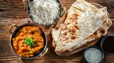 Hot madras paneer and vegetable masala with basmati rice served in original indian karahi pots.