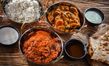 Hot madras paneer and vegetable masala with basmati rice served in original indian karahi pots.