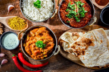 Hot madras paneer and vegetable masala with basmati rice served in original indian karahi pots.