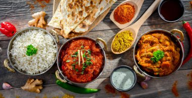 Hot madras paneer and vegetable masala with basmati rice served in original indian karahi pots.
