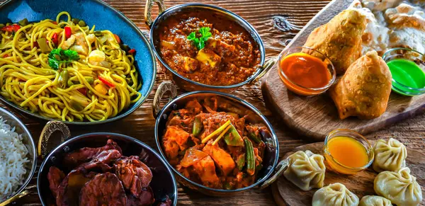 stock image Composition with indian dishes: samosa, pakora, palak paneer, jalfrezi, thukpa and naan bread