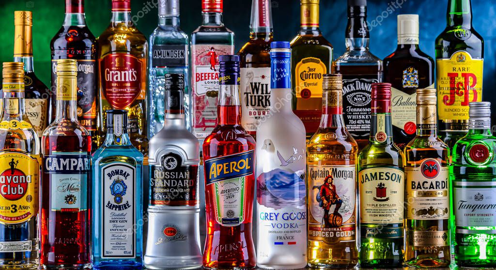 POZNAN, POL - NOV 29, 2023: Bottles of assorted global hard  liquor brands in a bar