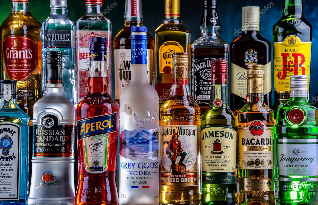 POZNAN, POL - NOV 29, 2023: Bottles of assorted global hard  liquor brands in a bar