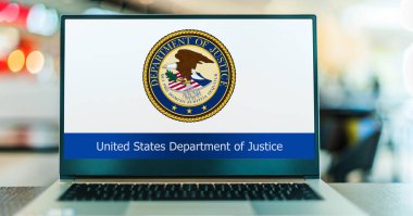 POZNAN, POL - DEC 5, 2023: Laptop computer displaying seal of The United States Department of Justice, a federal executive department of the US government clipart