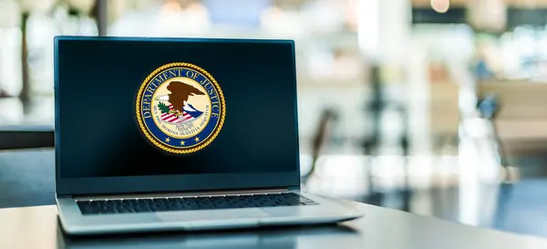 stock image POZNAN, POL - DEC 5, 2023: Laptop computer displaying seal of The United States Department of Justice, a federal executive department of the US government