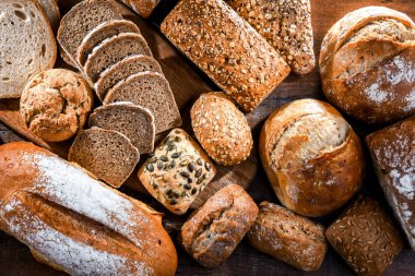 Assorted bakery products including loaves of bread and rolls