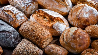 Assorted bakery products including loaves of bread and rolls