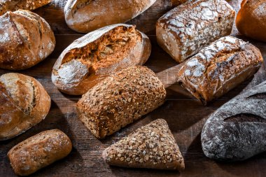 Assorted bakery products including loaves of bread and rolls