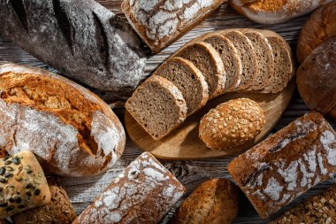 Assorted bakery products including loaves of bread and rolls
