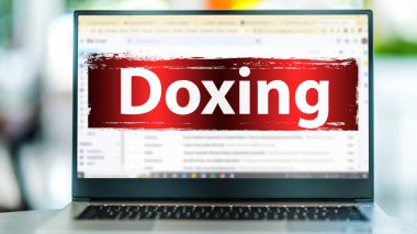 Laptop computer displaying the sign of doxing on an internet email site clipart
