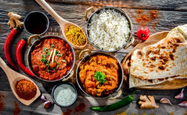 Hot madras paneer and vegetable masala with basmati rice served in original indian karahi pots.