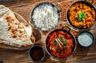 Hot madras paneer and vegetable masala with basmati rice served in original indian karahi pots.