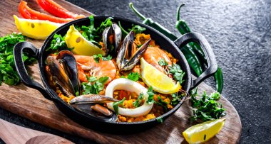 Seafood paella served in a cast iron pan.